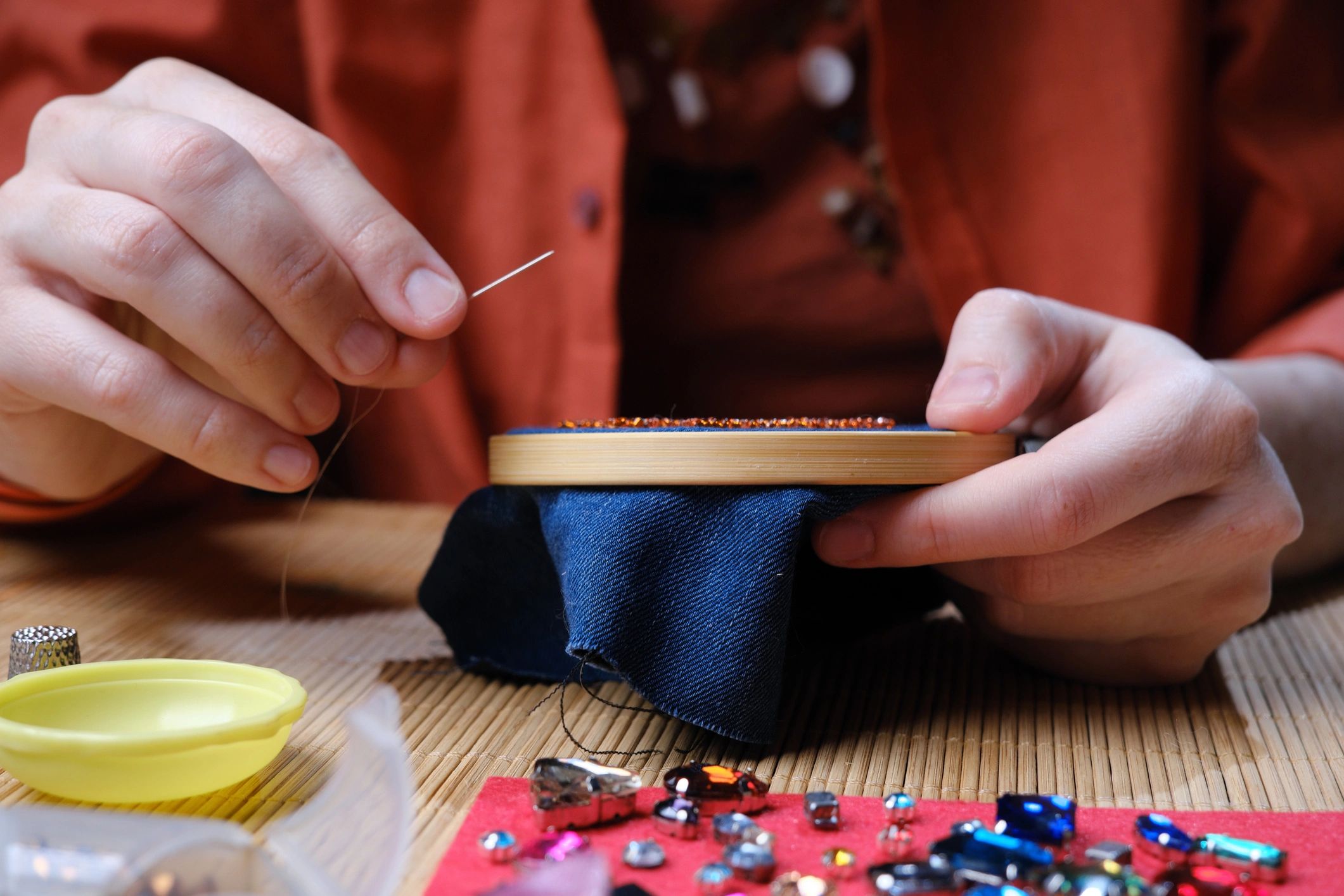 Hands working on a craft project, representing made-to-order work