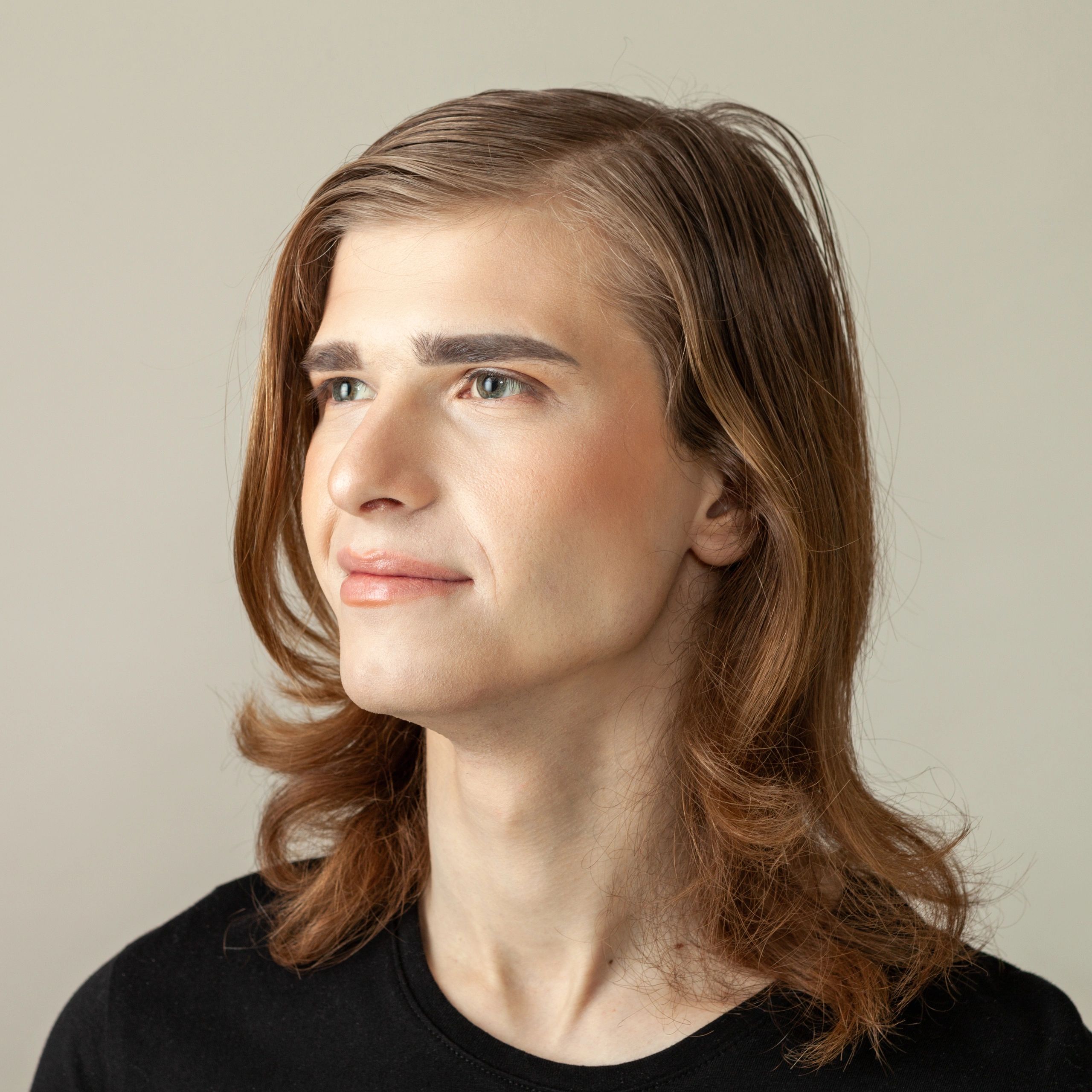 Portrait of a smiling person on a beige background