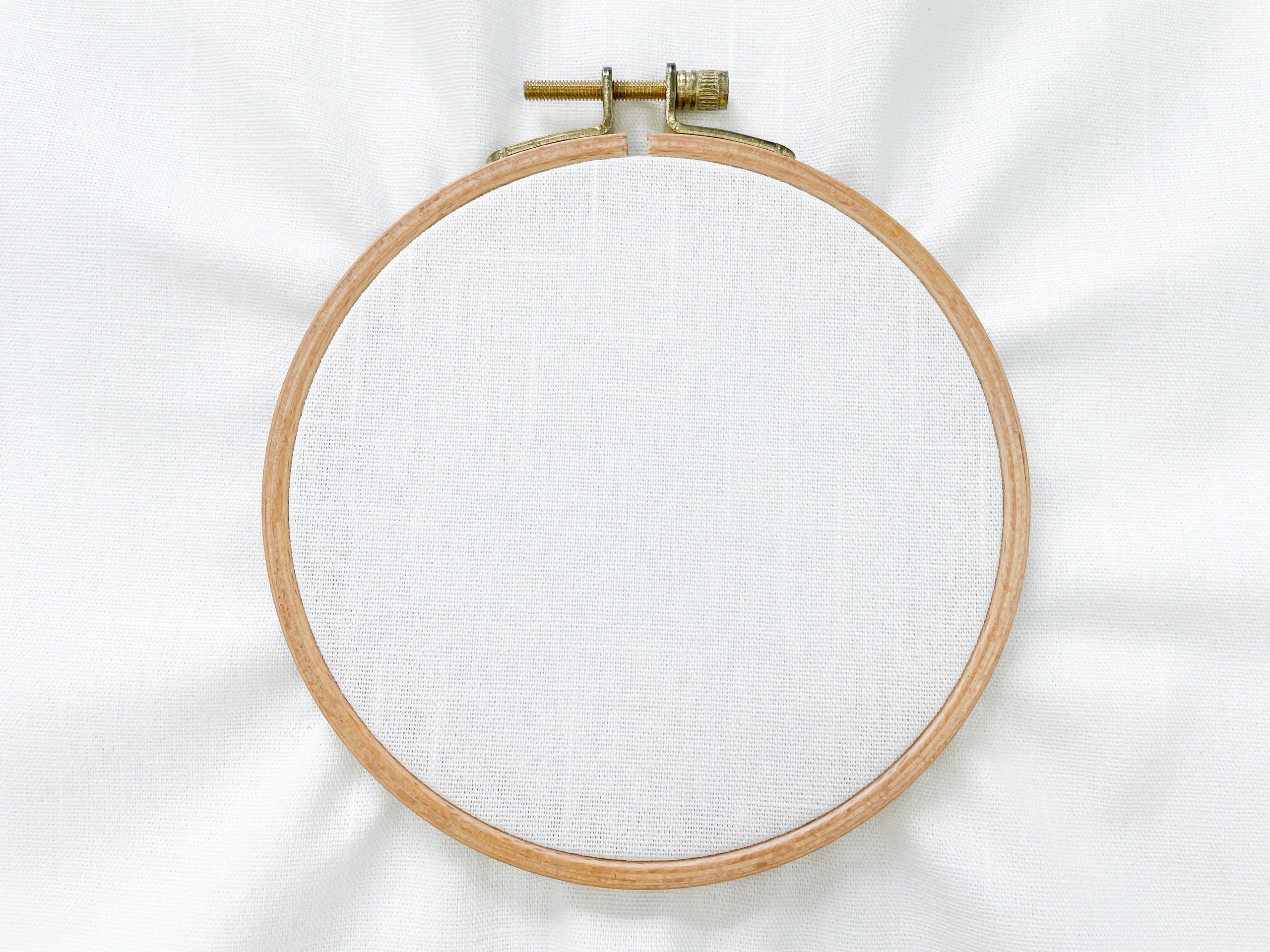 Embroidery hoop and fabric flat lay for personalized stitching