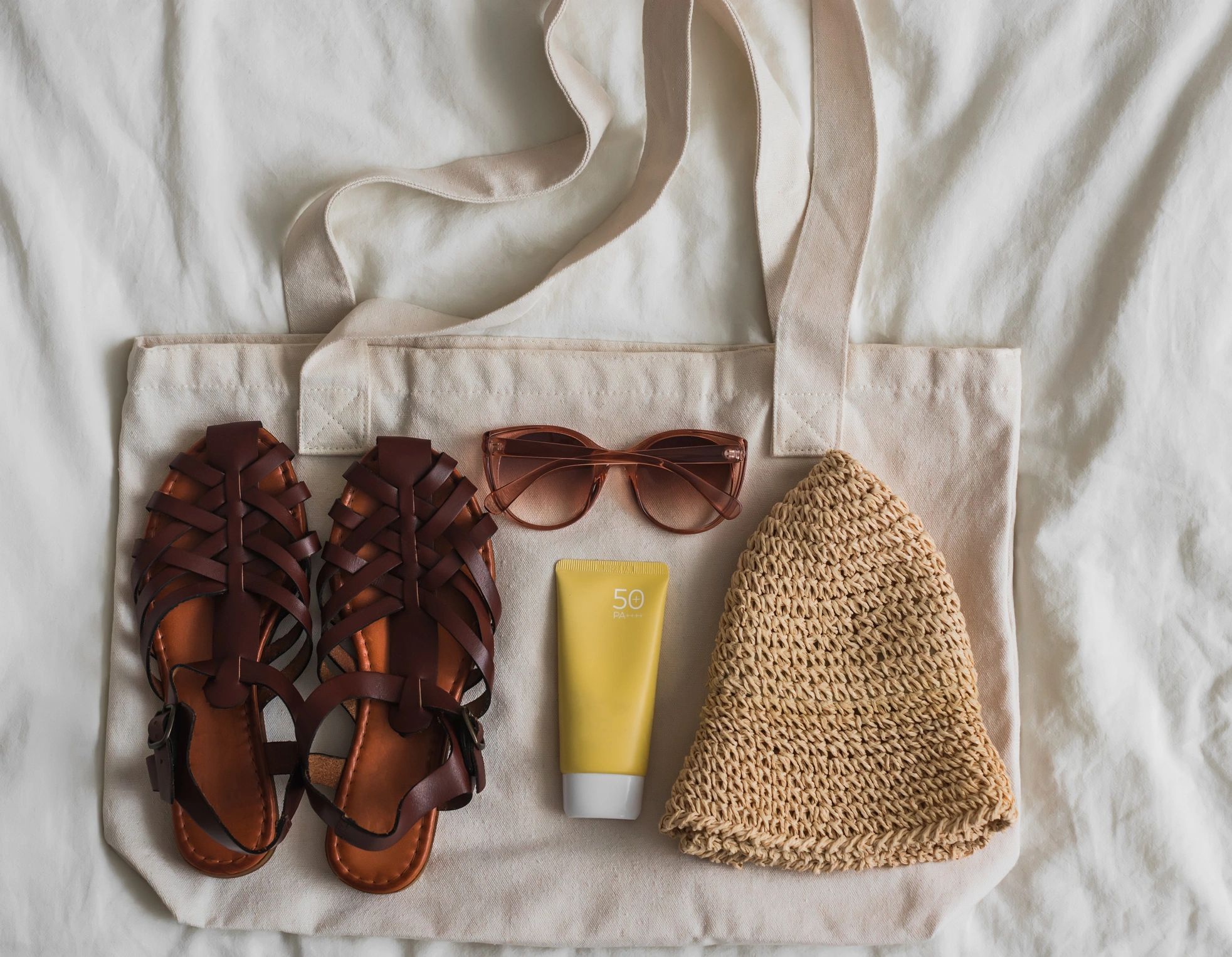 Canvas tote bag styled in a feminine flat lay